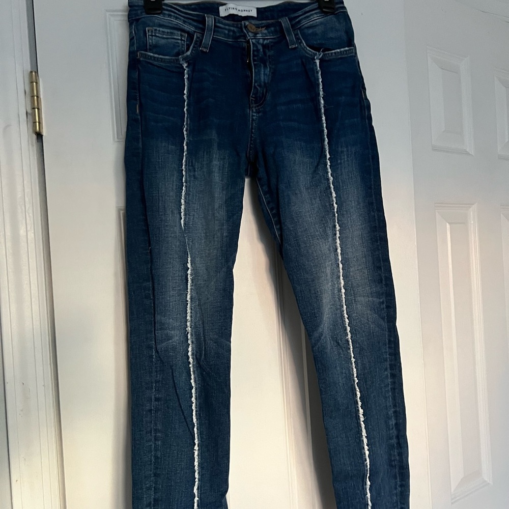 Flying Monkey dark wash skinny jeans with white stitching on front of each leg